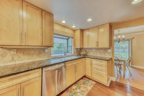 a kitchen with granite countertop stainless steel appliances and cabinets