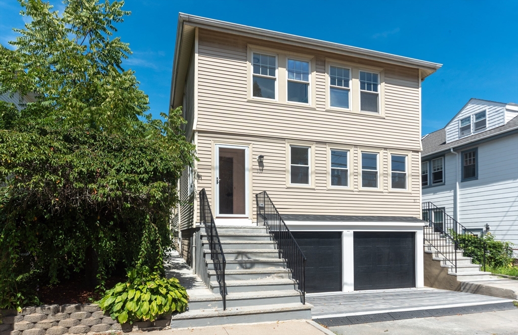 331 Vermont Street, Unit 1 Boston, MA 02132 - Photo 1 of 8 a front view of a house with a garden