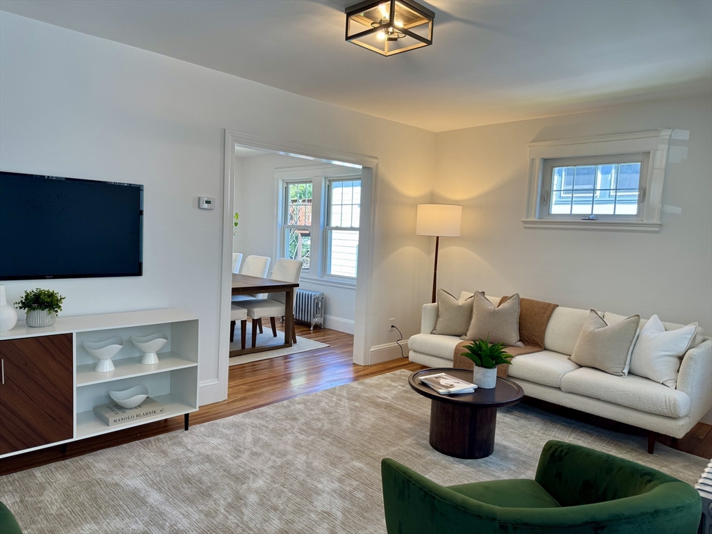 331 Vermont Street, Unit 1 Boston, MA 02132 - Photo 3 of 8 a living room with furniture and a flat screen tv