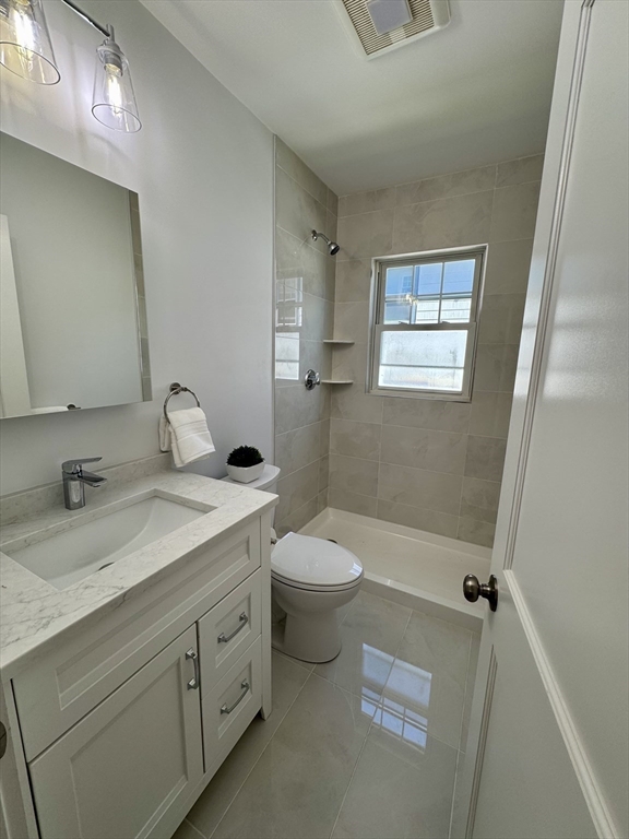 331 Vermont Street, Unit 1 Boston, MA 02132 - Photo 6 of 8 a bathroom with a sink a toilet and shower
