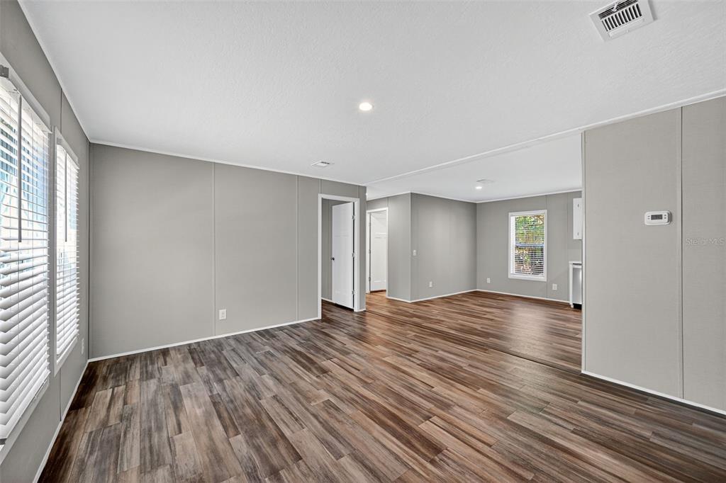 134 Weerts Road San Mateo, FL 32187 - Photo 13 of 32 a view of empty room with wooden floor and fan