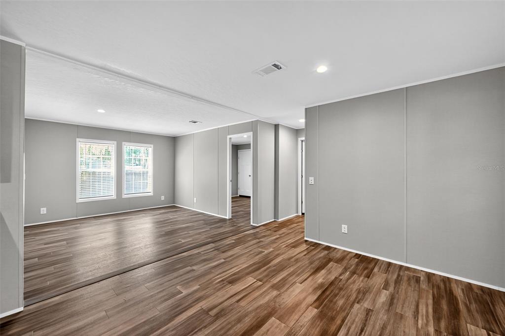 134 Weerts Road San Mateo, FL 32187 - Photo 16 of 32 a view of an empty room with wooden floor and window