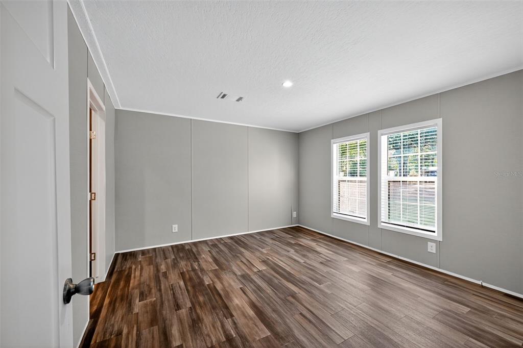 134 Weerts Road San Mateo, FL 32187 - Photo 17 of 32 an empty room with wooden floor and windows