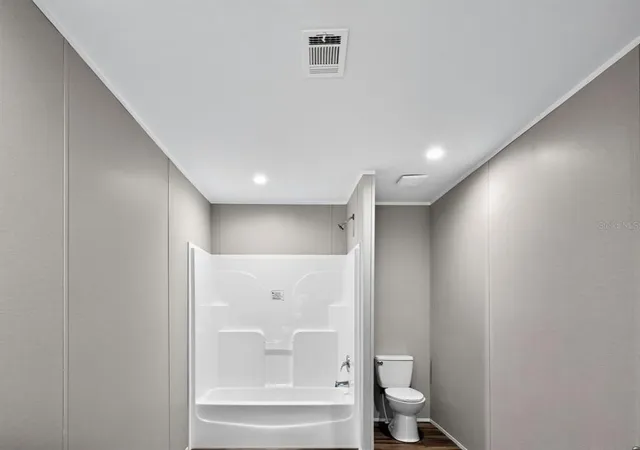 a bathroom with a bathtub and a toilet