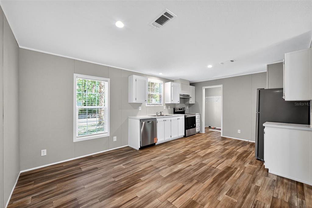 134 Weerts Road San Mateo, FL 32187 - Photo 7 of 32 a kitchen with a white cabinets and white appliances