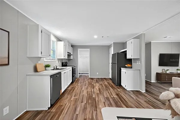 a kitchen with white cabinets and stainless steel appliances