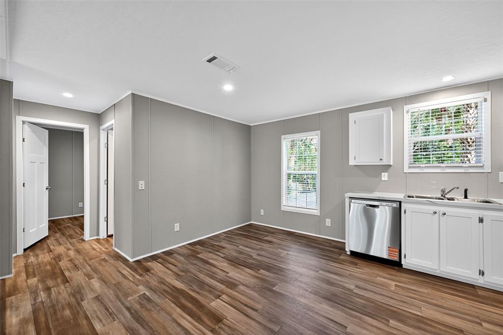 134 Weerts Road San Mateo, FL 32187 - Photo 10 of 32 a view of a kitchen with a sink dishwasher and wooden floor