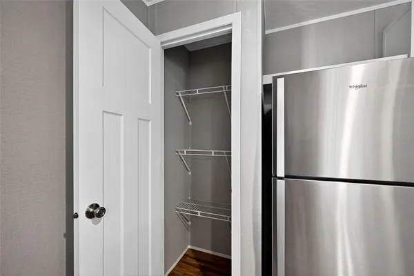 a metallic refrigerator freezer and a refrigerator in a kitchen