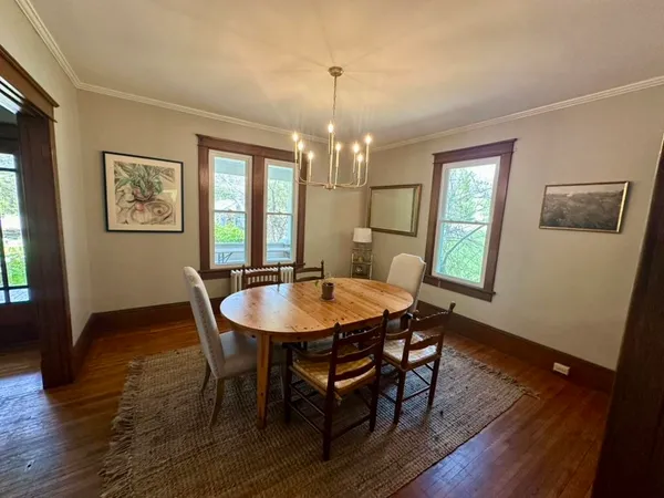 a view of a dining room with furniture window and wooden floor