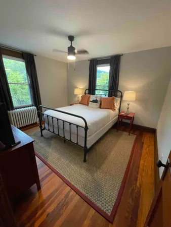 a bed room with a bed window and a chair