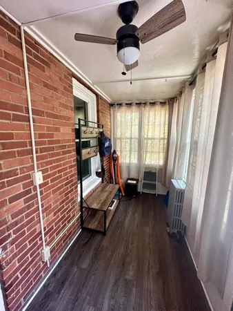 a view of a livingroom with furniture and a ceiling fan