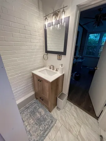a bathroom with a sink a mirror and shower