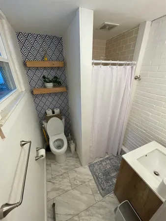 a bathroom with a toilet and a shower