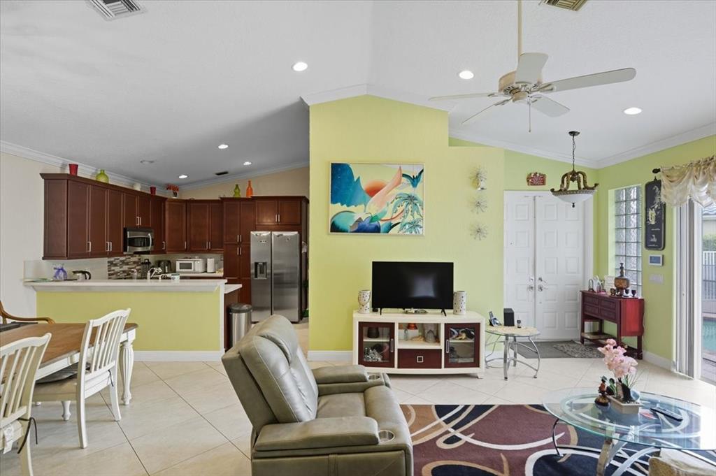 7631 Northwest 87th Terrace Tamarac, FL 33321 - Photo 16 of 23 a living room with furniture and a flat screen tv