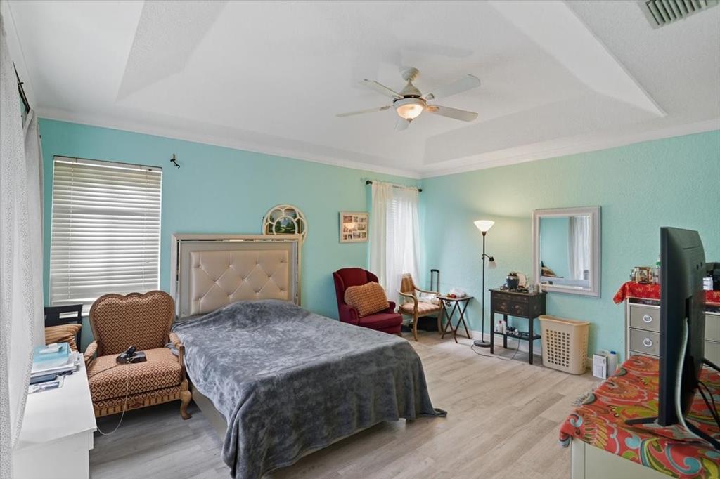 7631 Northwest 87th Terrace Tamarac, FL 33321 - Photo 22 of 23 a bedroom with furniture and a flat screen tv