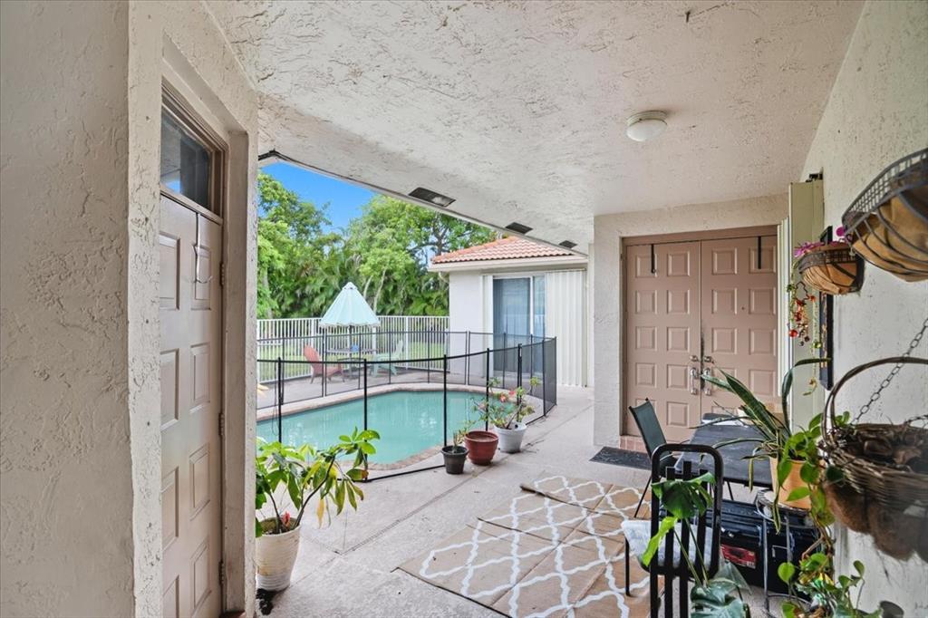 7631 Northwest 87th Terrace Tamarac, FL 33321 - Photo 8 of 23 a view of a patio with table and chairs and potted plants
