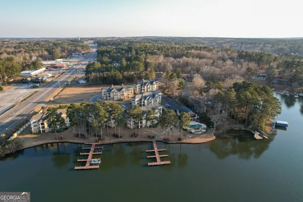 an aerial view of lake and residential houses with outdoor space