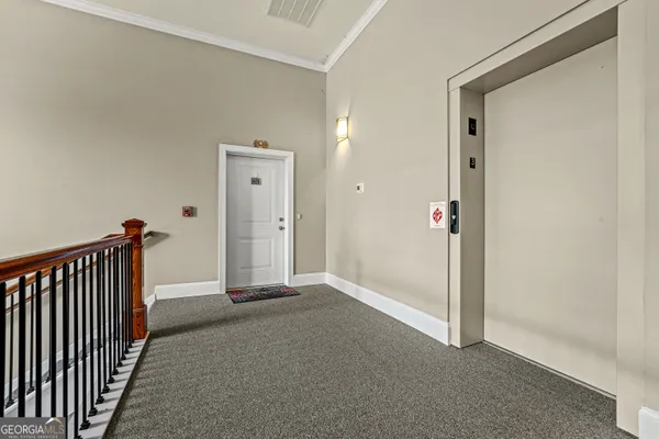 a view of a hallway with entryway door
