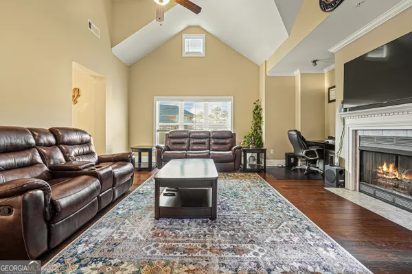 a living room with fireplace furniture and a flat screen tv