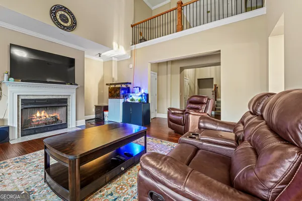 a living room with furniture pool and a flat screen tv