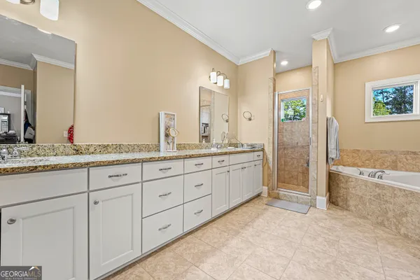 a spacious bathroom with double sink and a mirror