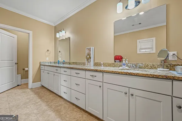 a bathroom with double sink and a mirror