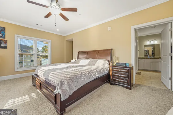 a bedroom with a bed and ceiling fan
