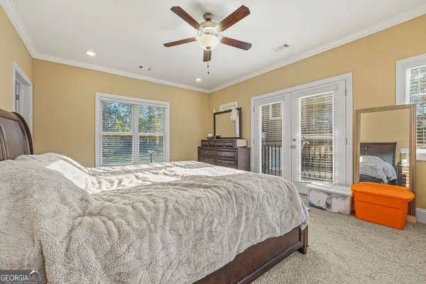a bedroom with a bed and glass door