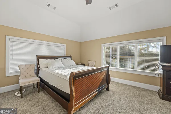 a bed sitting in a room next to a window