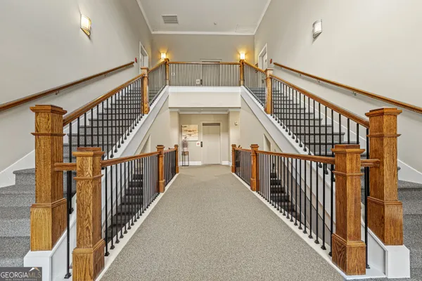 a view of staircase with wooden floor and a chandelier