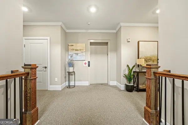 a view of hallway with furniture and a living room