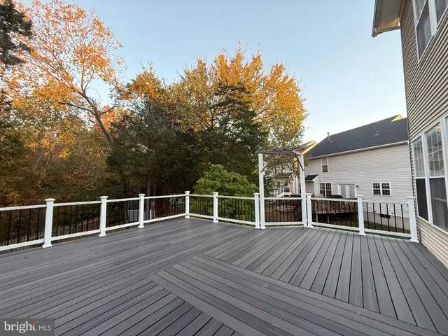a view of a balcony with wooden floor and fence