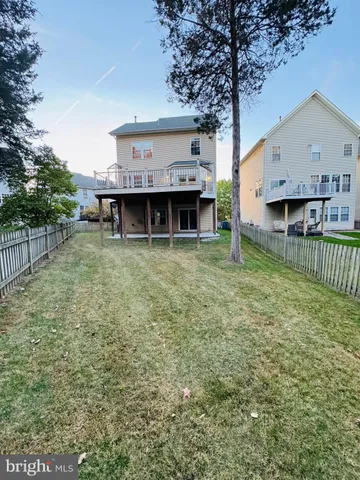a view of a house with a yard and sitting area