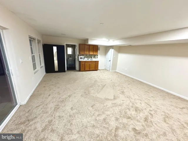 a view of an empty room with windows