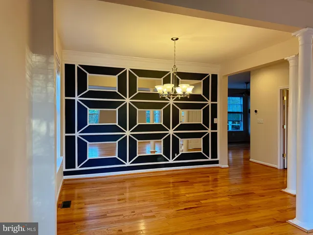 a view of wooden floor and windows in a room