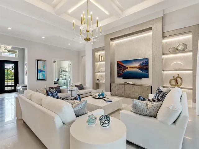 a bedroom with a large bed couch and a large window