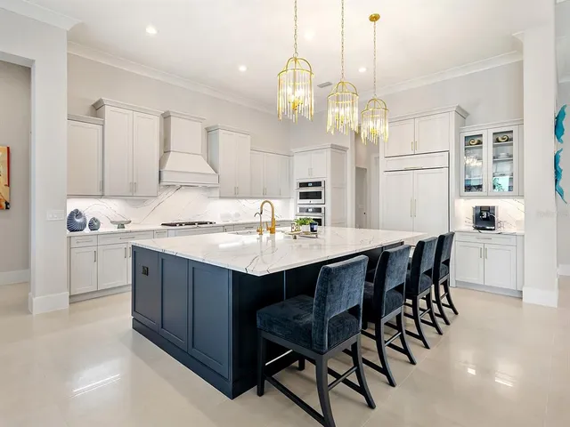 a large kitchen with kitchen island a sink stainless steel appliances and cabinets