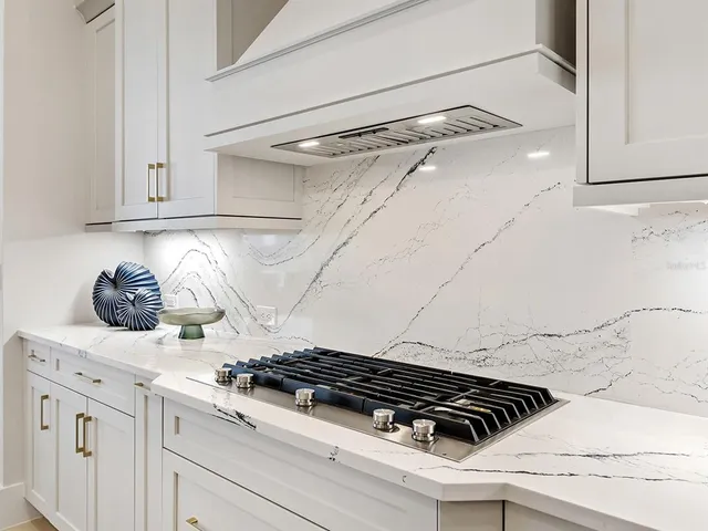 a living room with furniture a ceiling fan and a large window