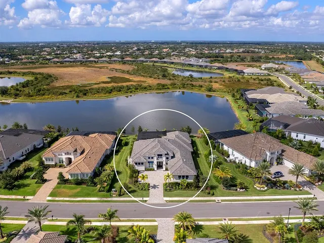 an aerial view of a house with swimming pool garden and mountain view in back