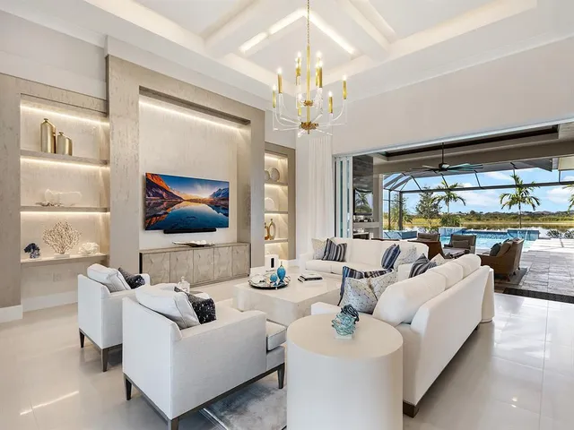 a bedroom with a large bed and a chandelier