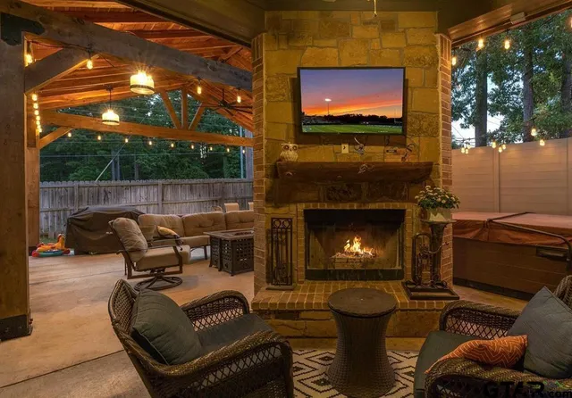 a living room with furniture a flat screen tv and a fireplace