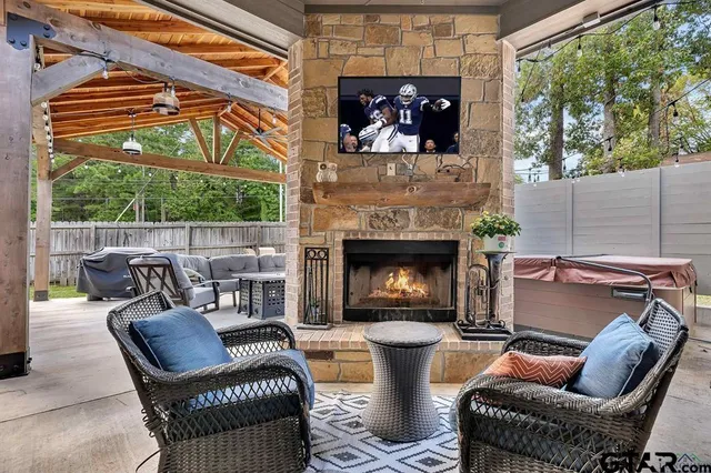 a living room with furniture a fireplace and a floor to ceiling window