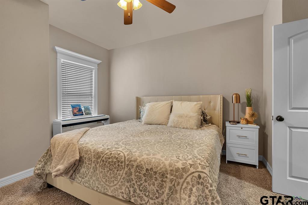 2001 Winding Run Lane Longview, TX 75605 - Photo 23 of 45 a bedroom with a bed and a chandelier