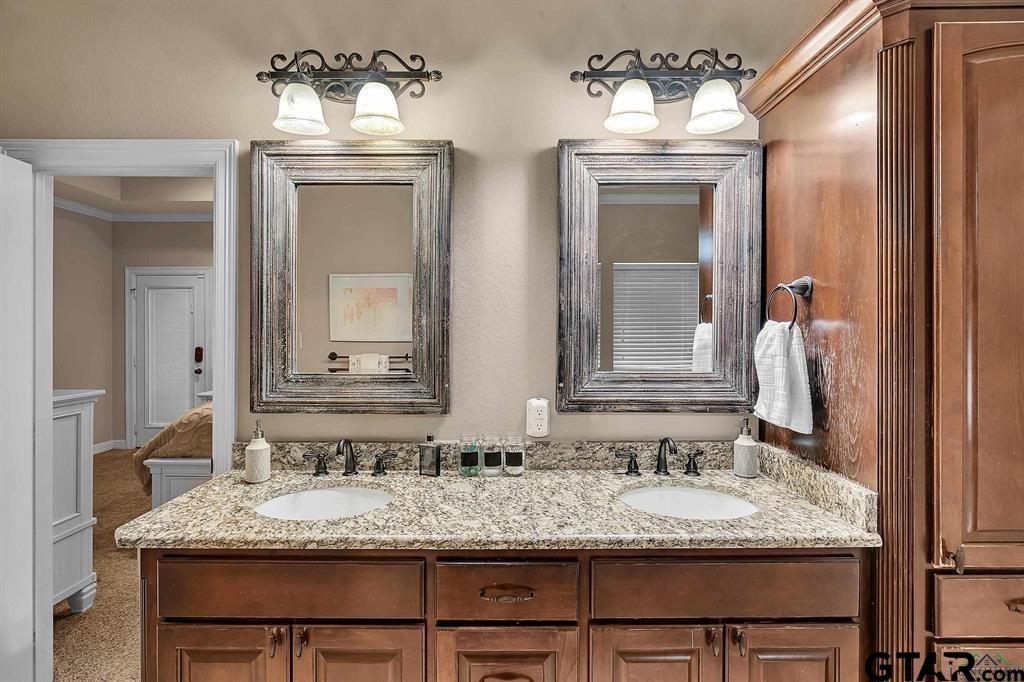 2001 Winding Run Lane Longview, TX 75605 - Photo 27 of 45 a bathroom with a granite countertop sink and a mirror