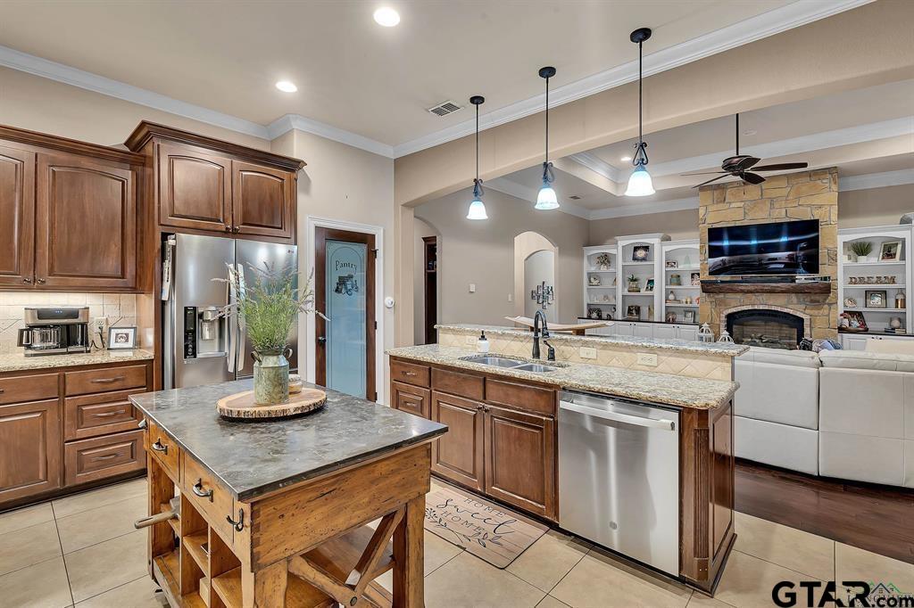 2001 Winding Run Lane Longview, TX 75605 - Photo 31 of 45 a kitchen with kitchen island granite countertop appliances cabinets and a sink