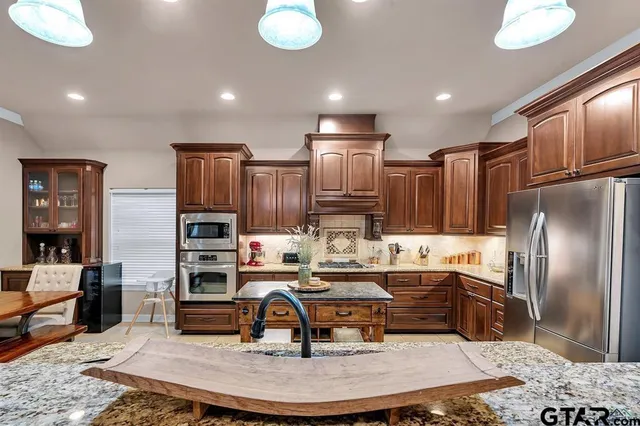 a kitchen with sink refrigerator and cabinets