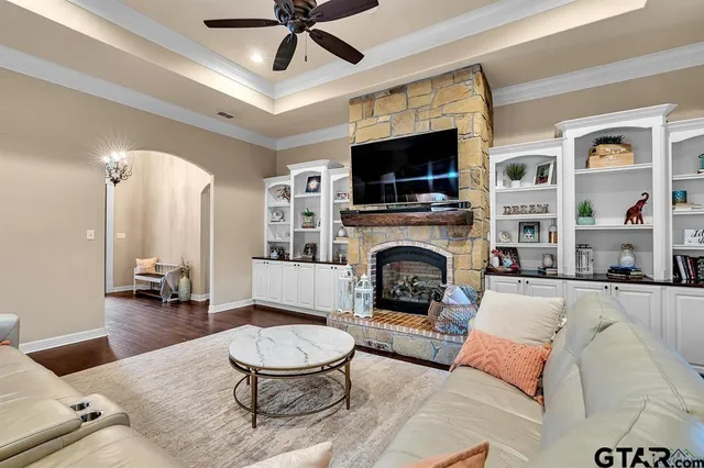 a living room with furniture a fireplace and a flat screen tv