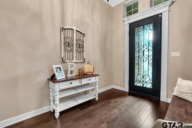 a view of an entryway with wooden floor and door
