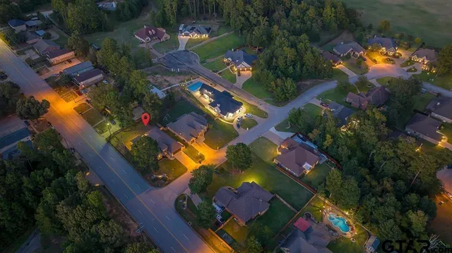 an aerial view of a houses with a yard