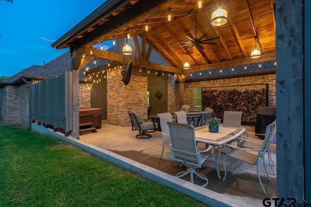 a view of a backyard with table and chairs a barbeque grill with wooden fence